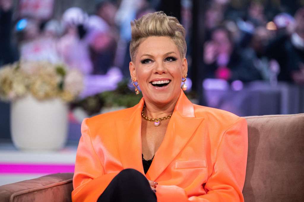 Pink smiling and sitting on a couch for an interview