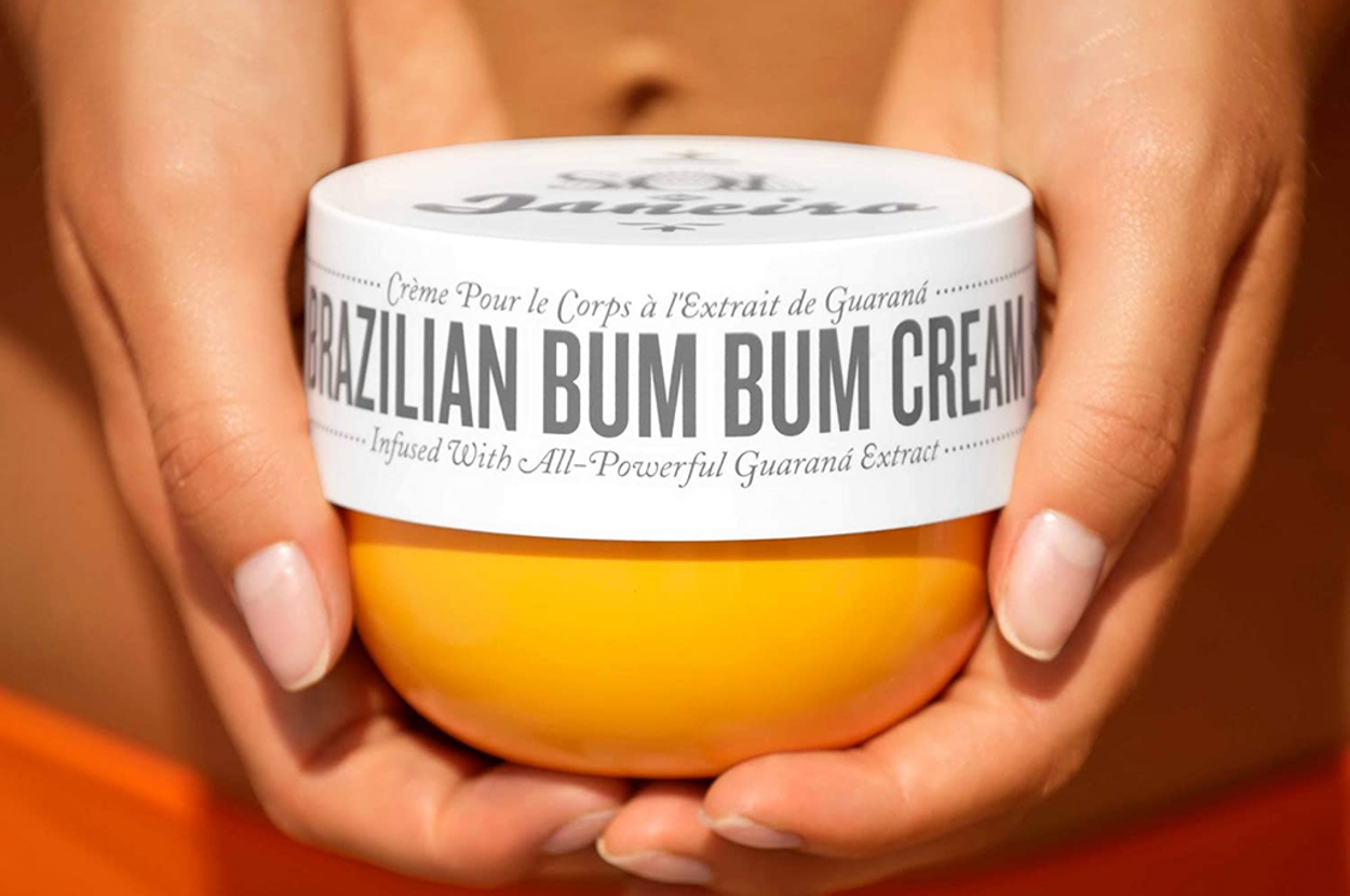 The jaw of cream in a model's hands 