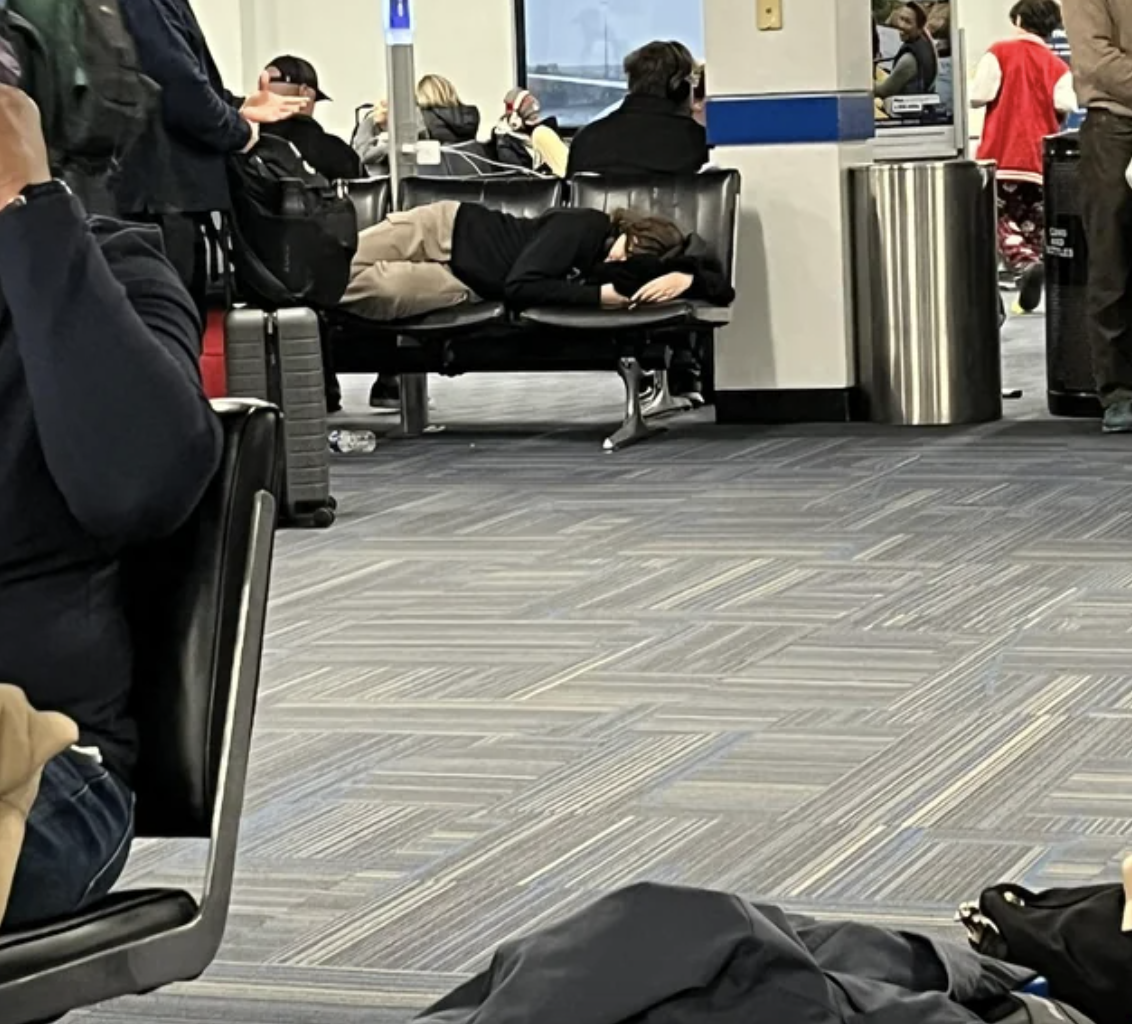 a woman sleeping in the airport