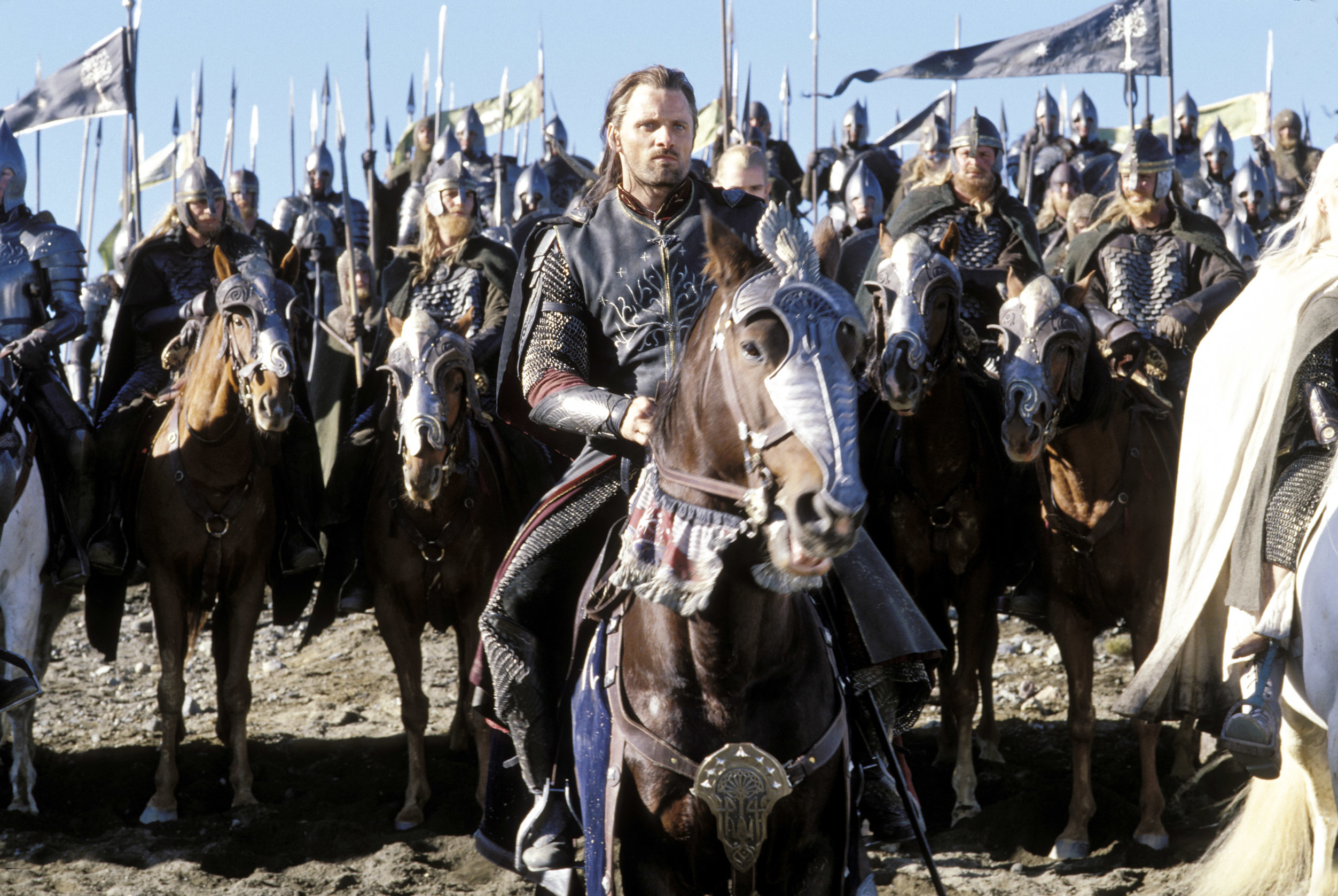 his character riding horseback with an army behind him