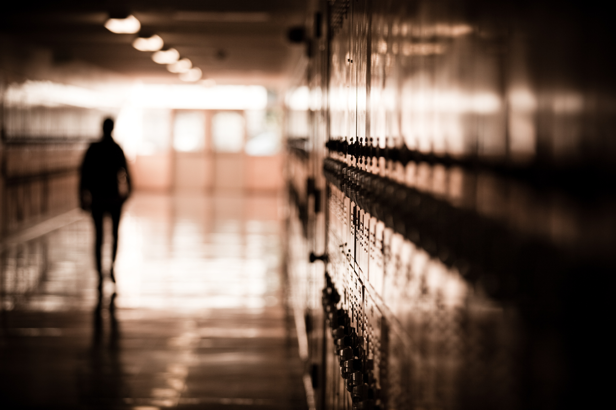 sole student walking a school hallway