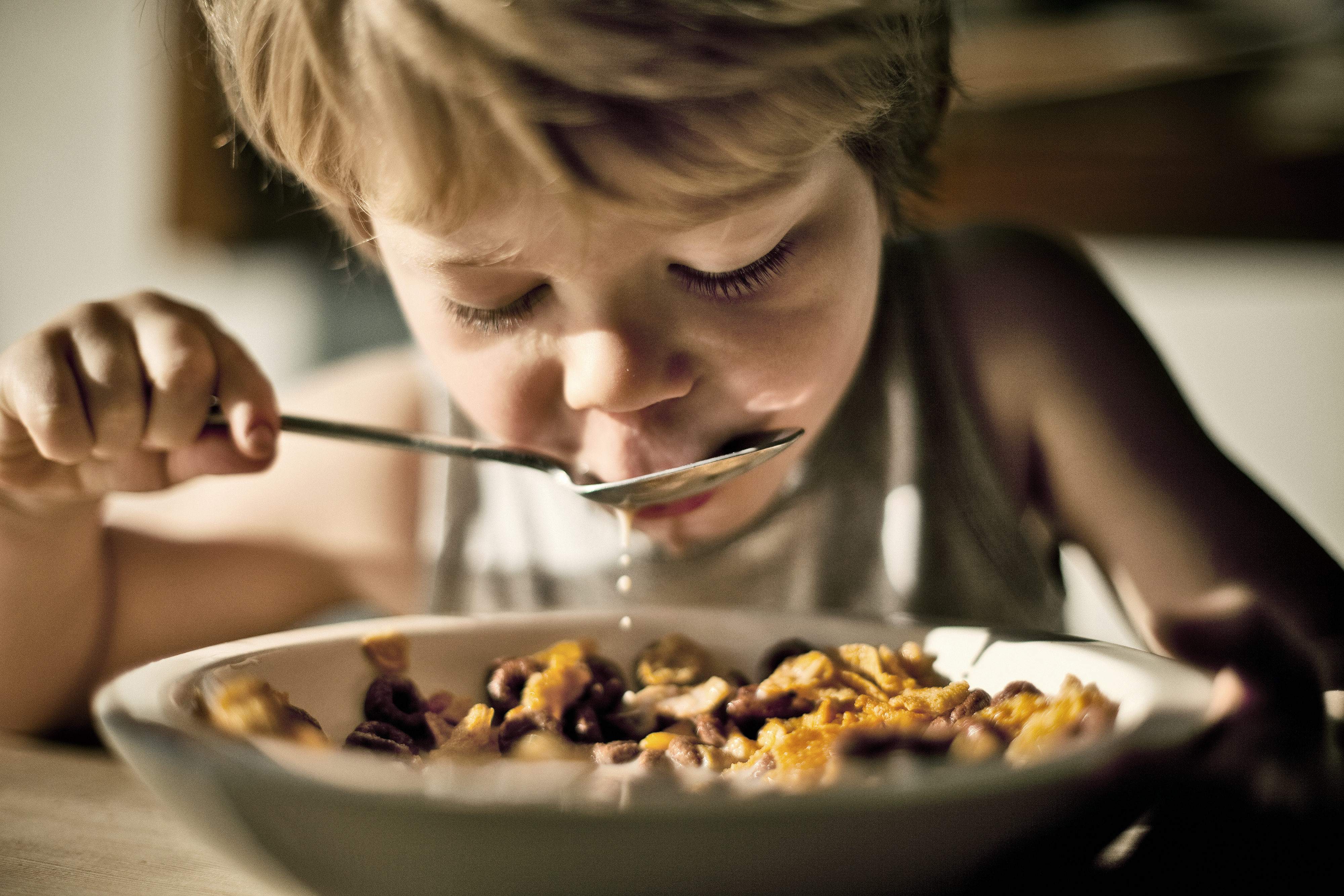 a young kid eating cereal