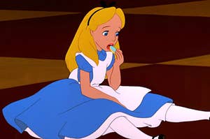 Alice from Alice in Wonderland eating a cookie