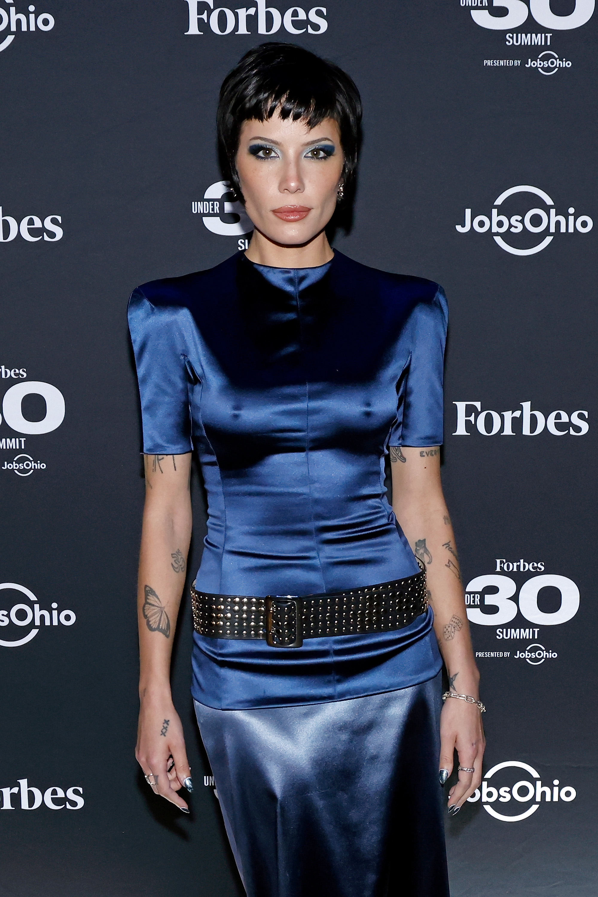 Close-up of Halsey in a satiny outfit at a media event