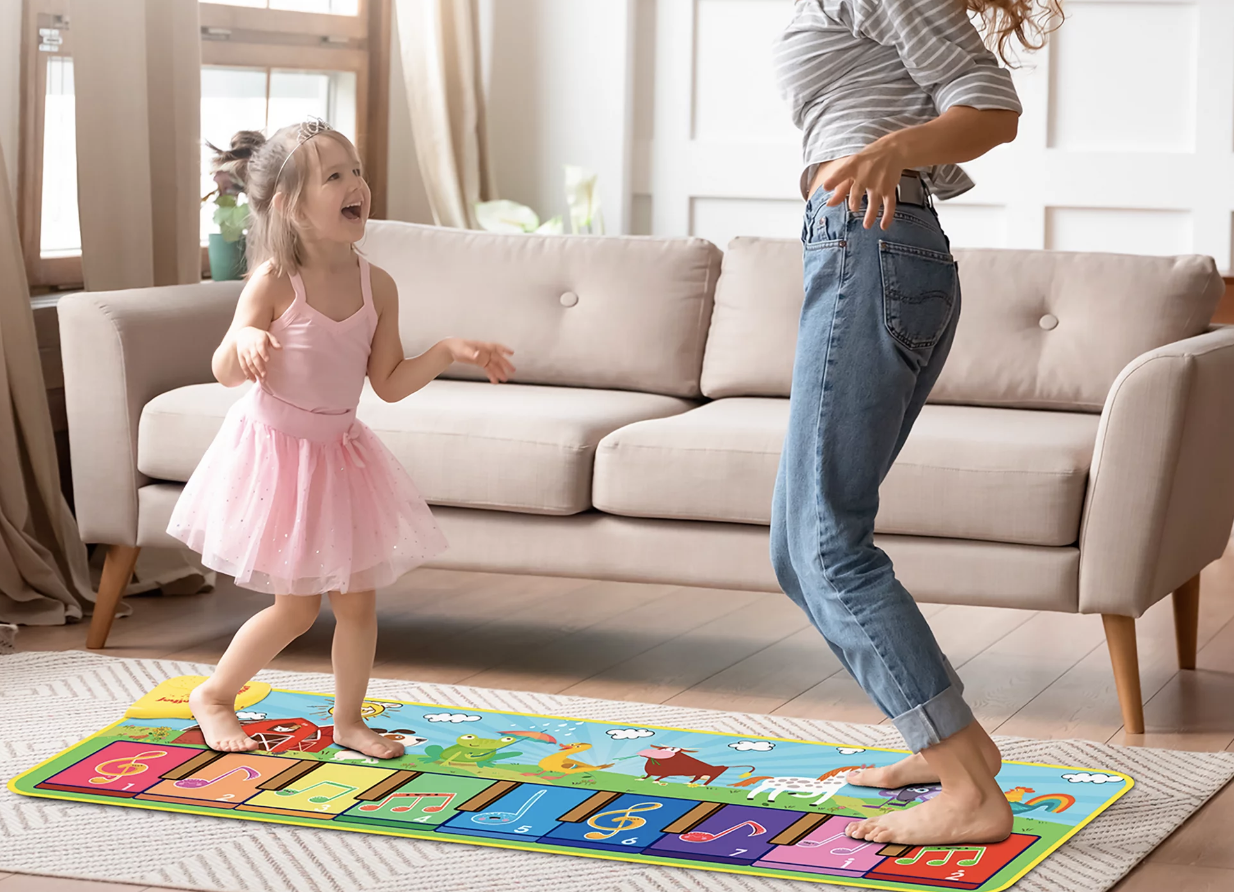 child playing on colorful step piano mat