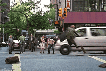 GIF of Brad flying up in the air on a city street