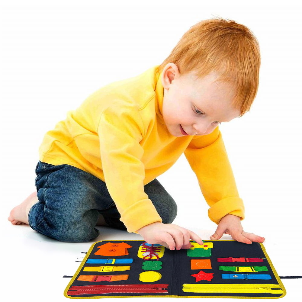 boy playing with clips on busy board