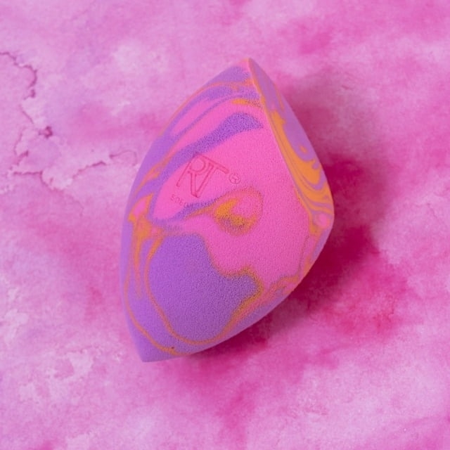 the tie dye make up sponge on a pink background