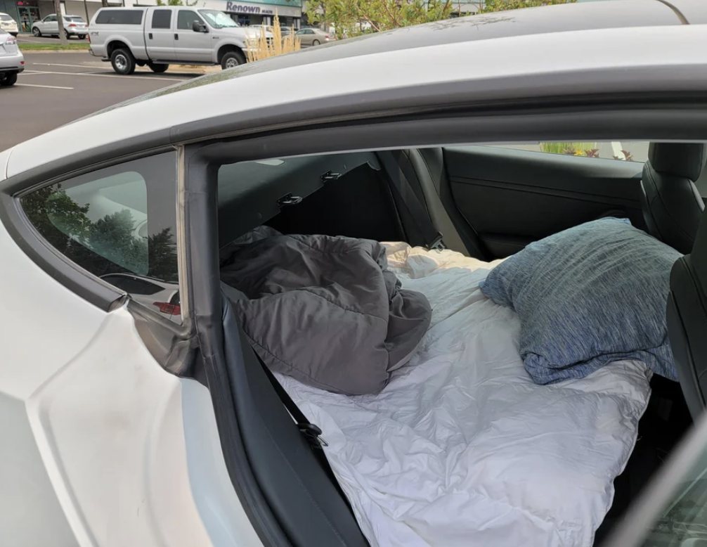 a bed made in the backseat of a car