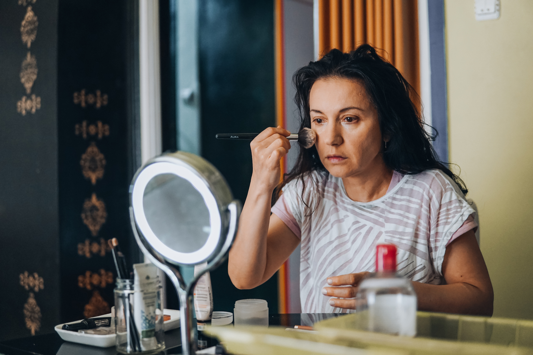 woman applying makeup
