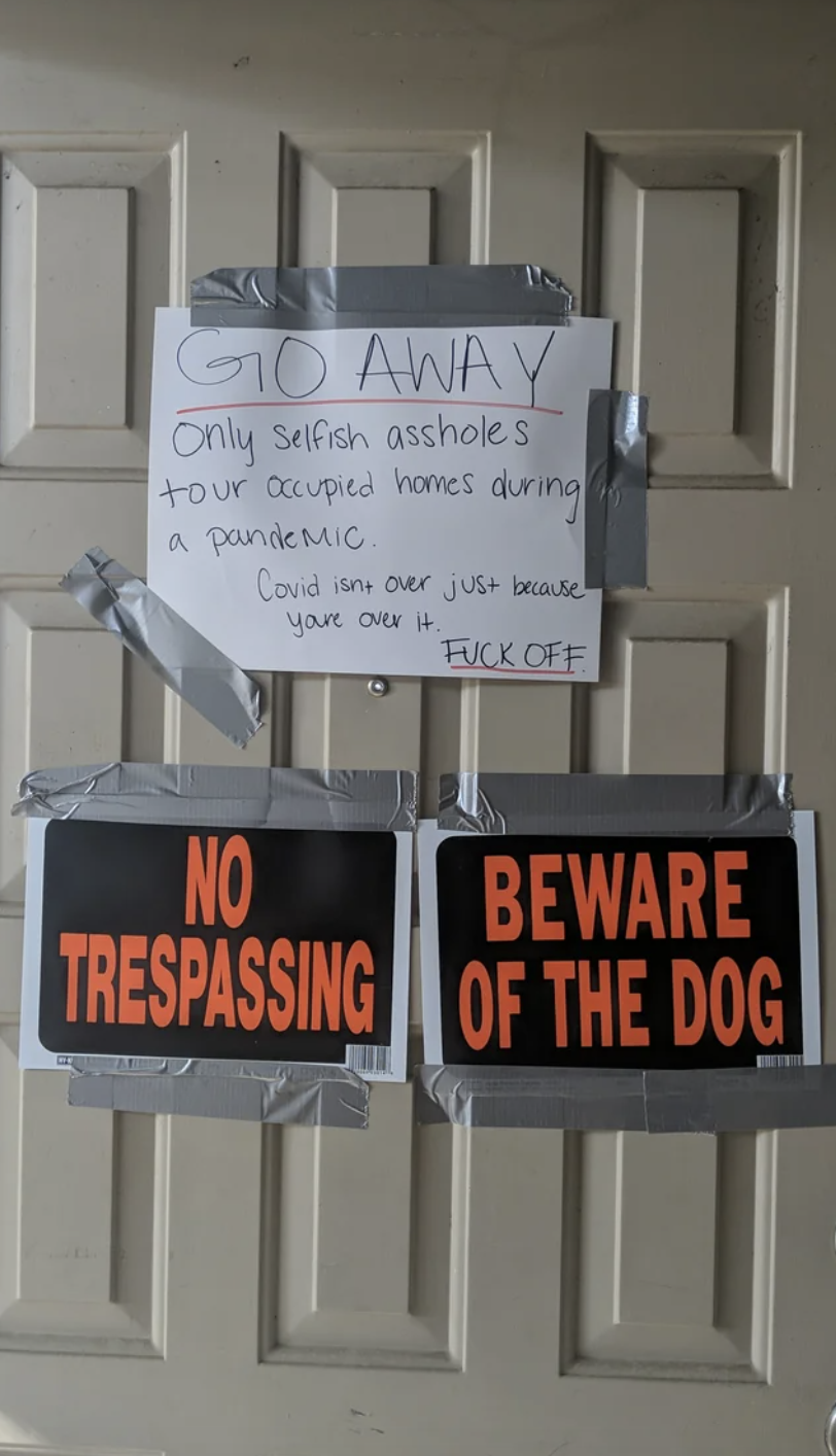 Signs on a door telling people to go away