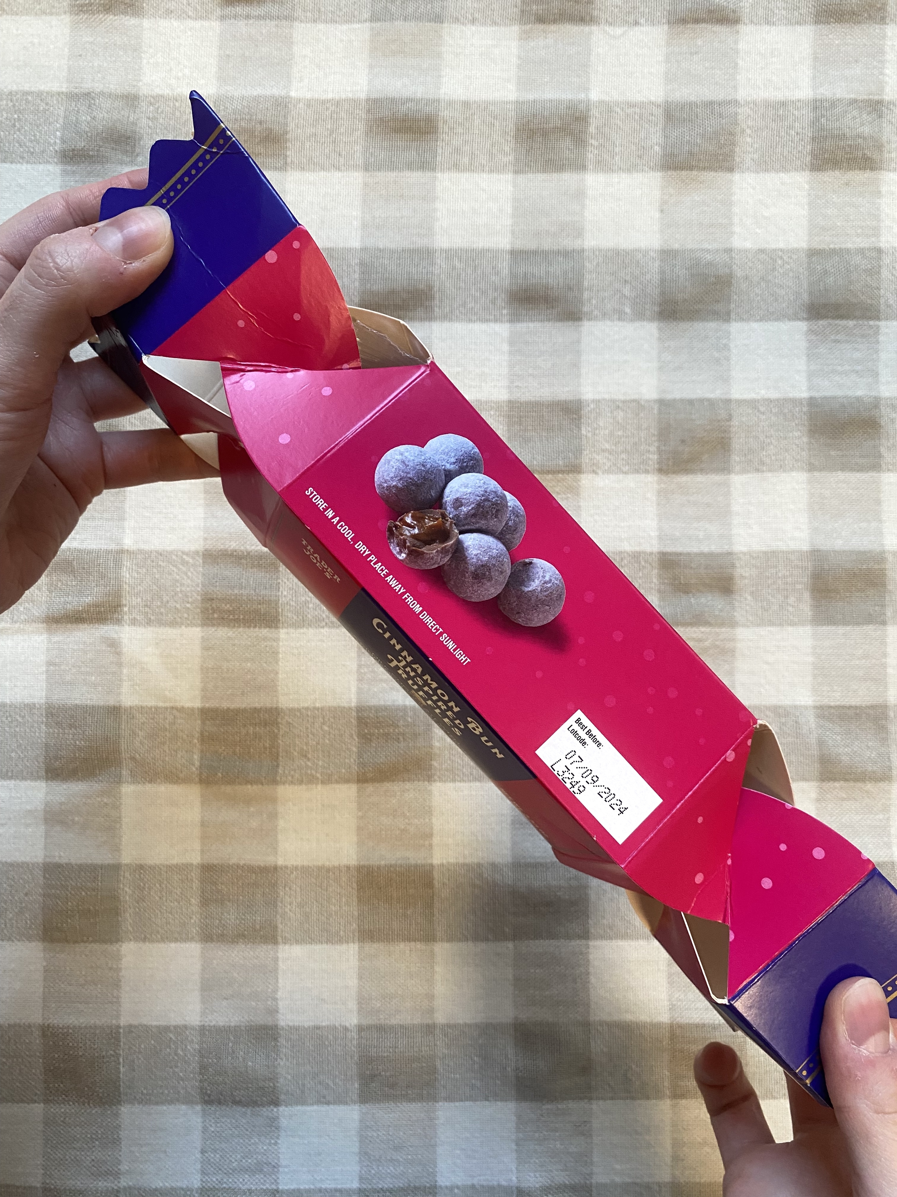 The author opening the box of Cinnamon Bun Truffles