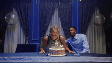 Taylor Swift blows out birthday cake full of candles.