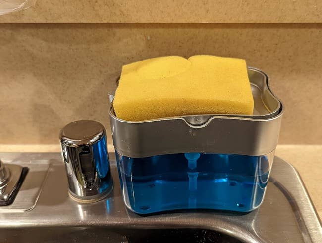 a reviewer photo of the dispenser/caddy with a sponge sitting on top