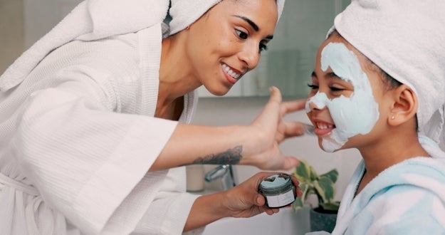 Mom, daughter and home skincare face mask of family bonding together with a house spa day