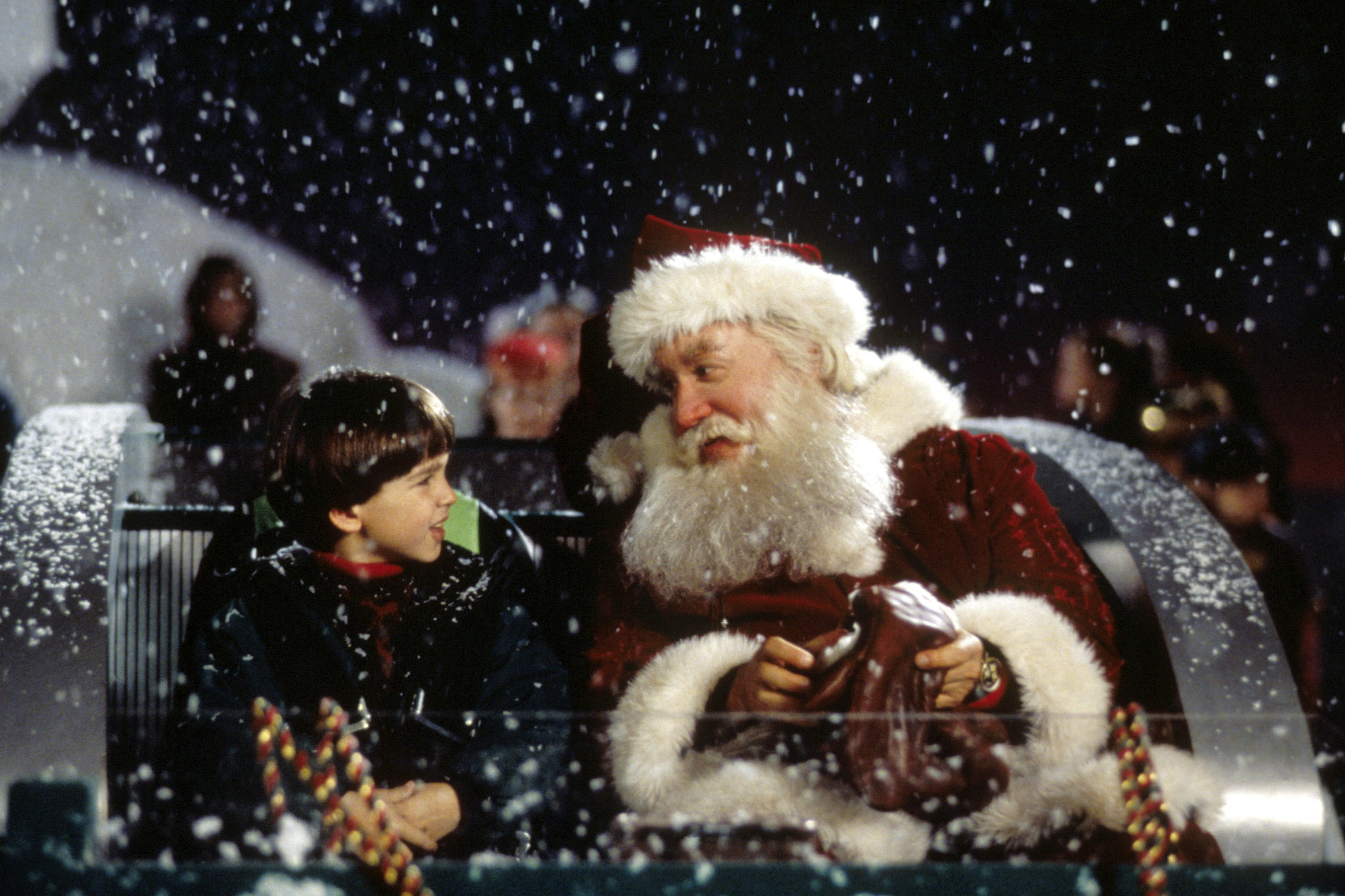 santa claus and his son riding in santa&#x27;s sleigh