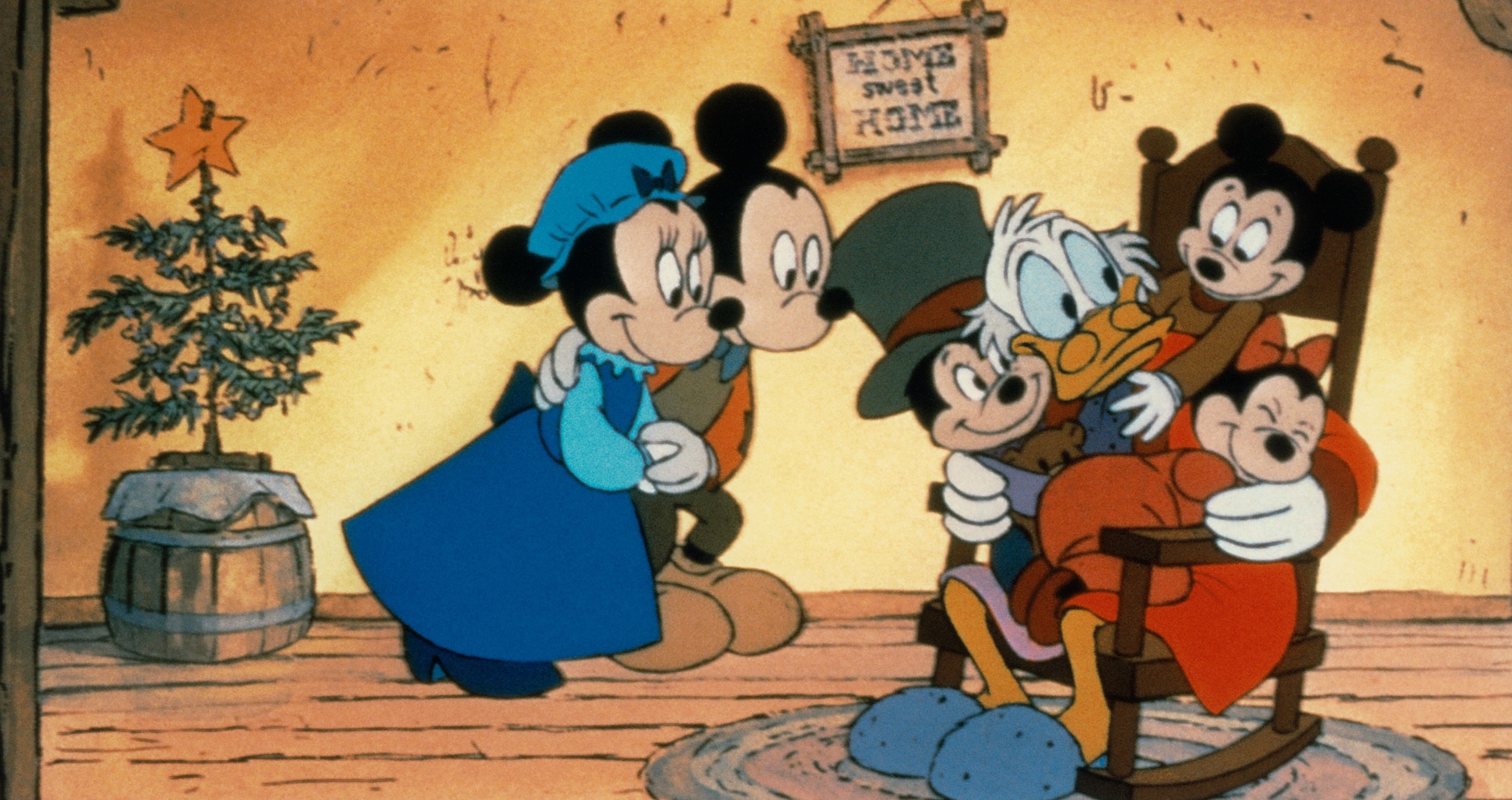 mickey and minnie holding hands and looking lovingly at scrooge mcduck who&#x27;s sitting in a rocking chair with all their children on his lap