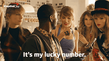 Taylor Swift points to a "13" on her hand and says "It's my lucky number."
