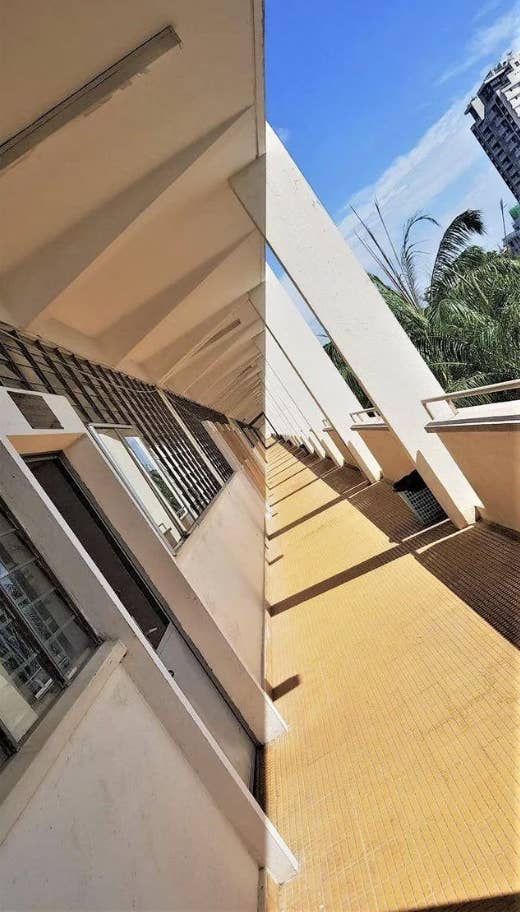 An outdoor motel balcony showing the sun illuminating one side