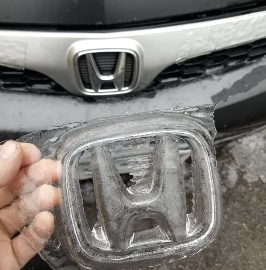 Person holding a frozen sheer Honda logo