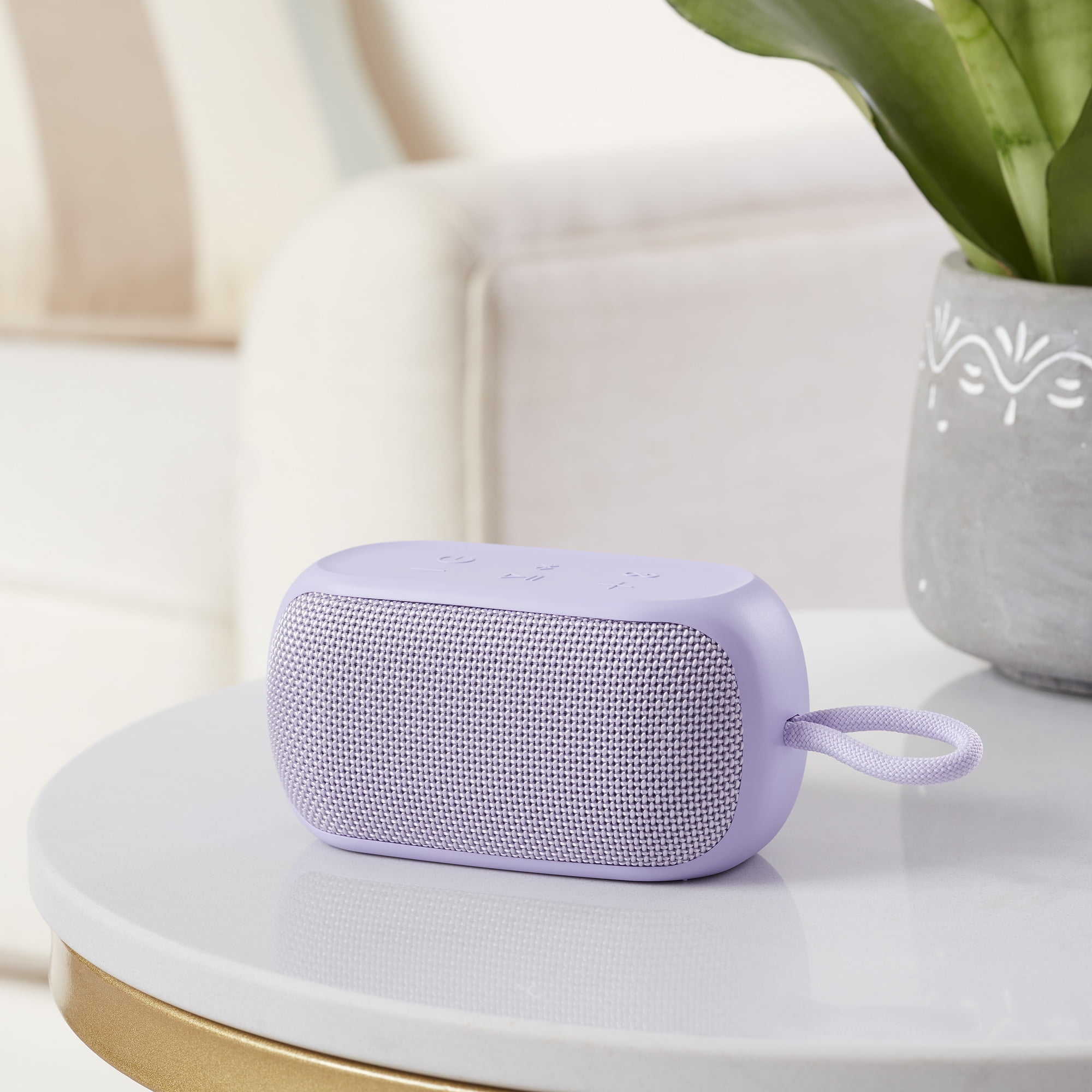 small lavender speaker on a table