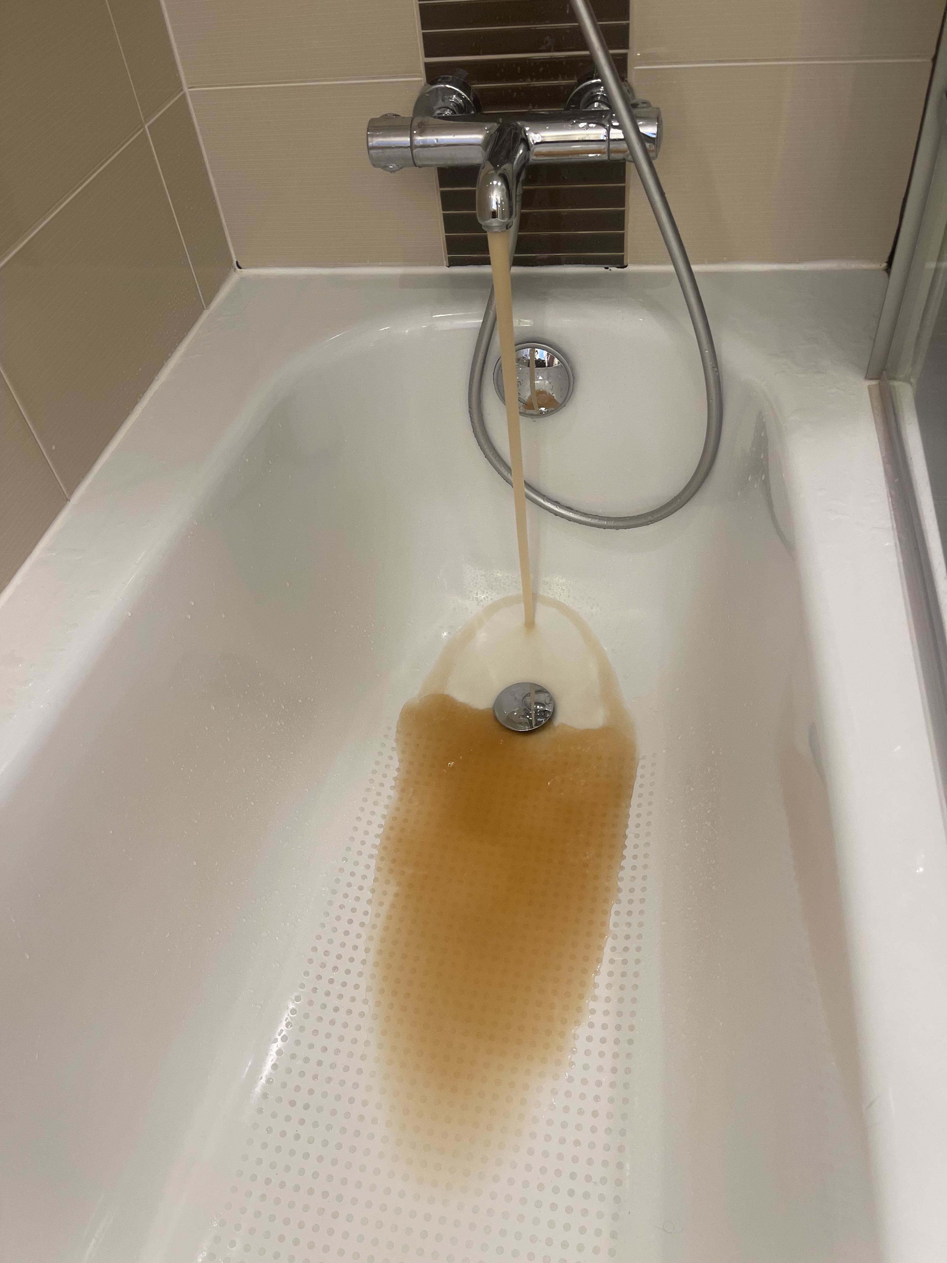 Yellowish brown water running out of a tap