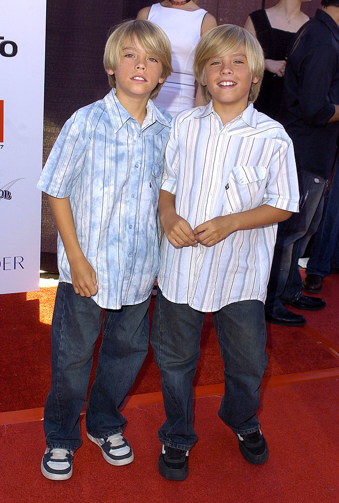 the two wearing matching outfits on the red carpet