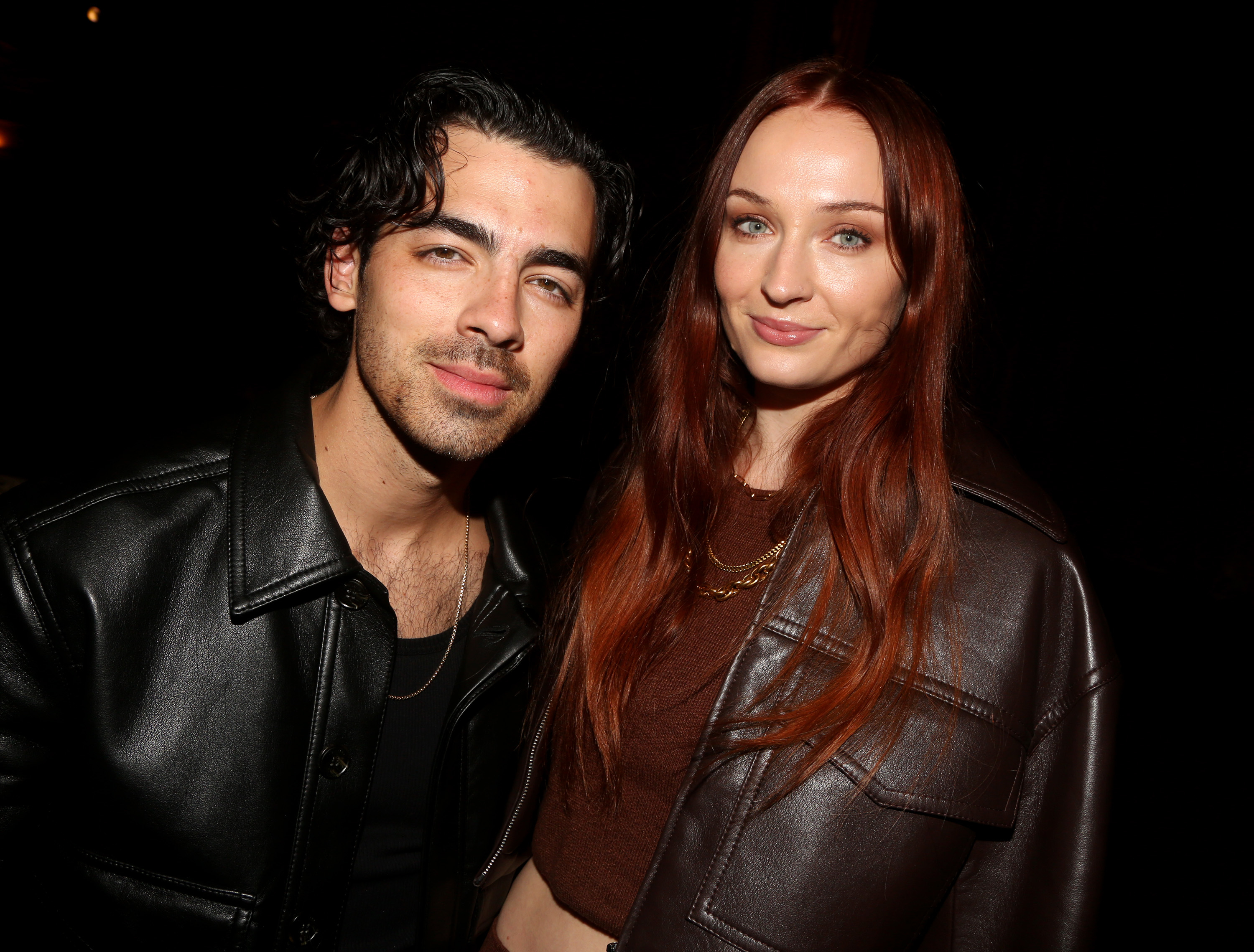 Close-up of Joe and Sophie wearing leather jackets