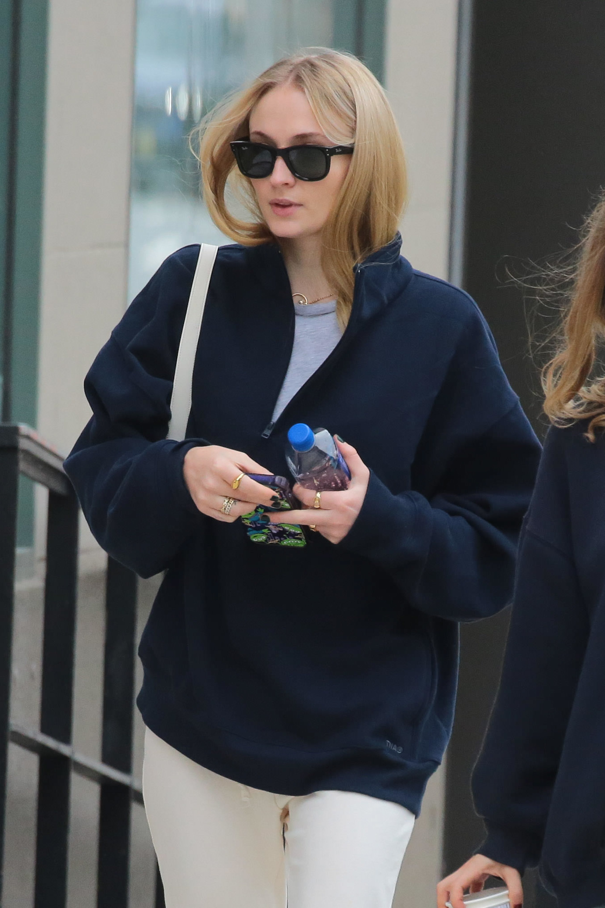 Sophie outside wearing sunglasses and a jacket
