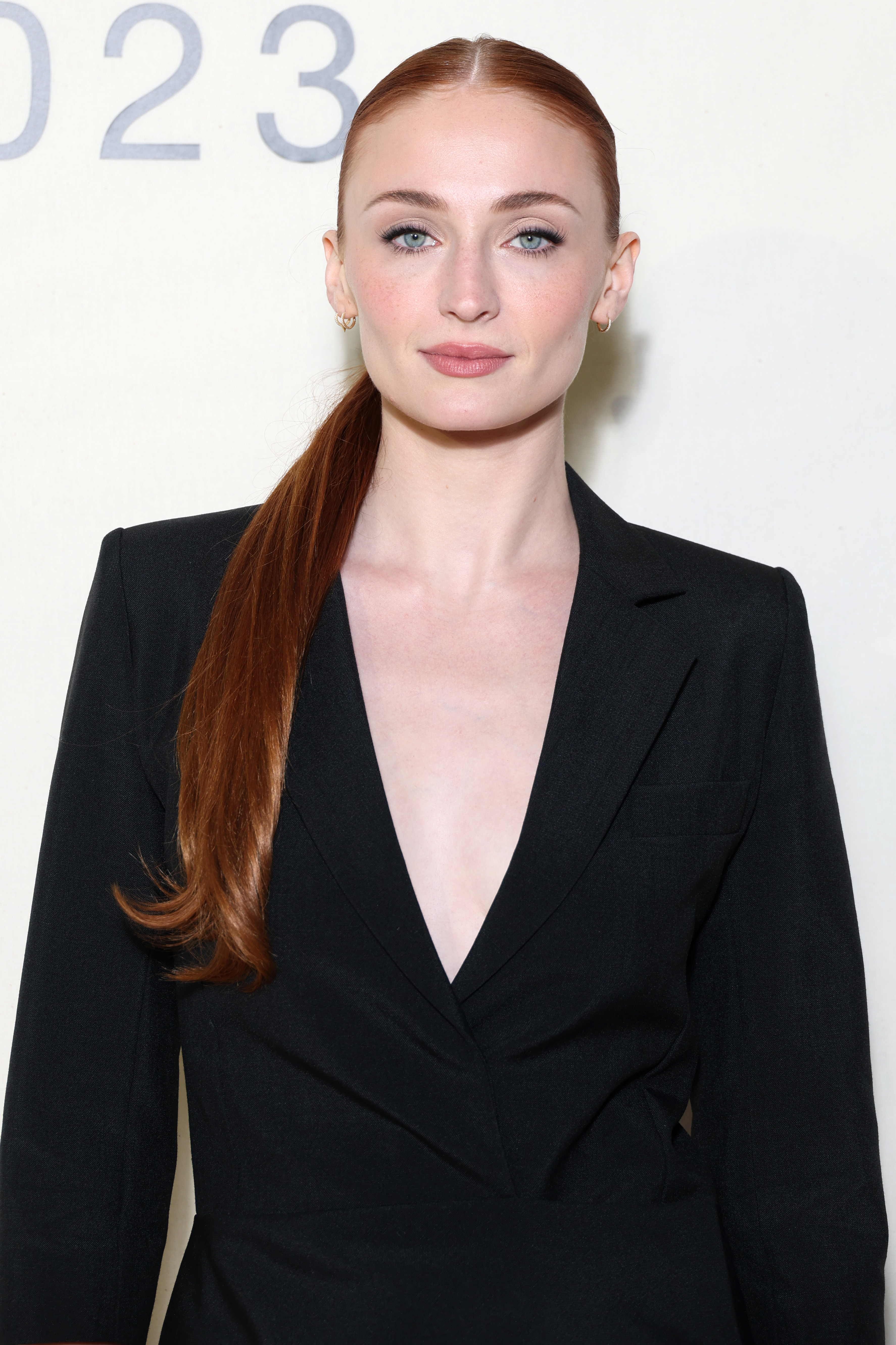 Sophie wearing a suit jacket at a media event