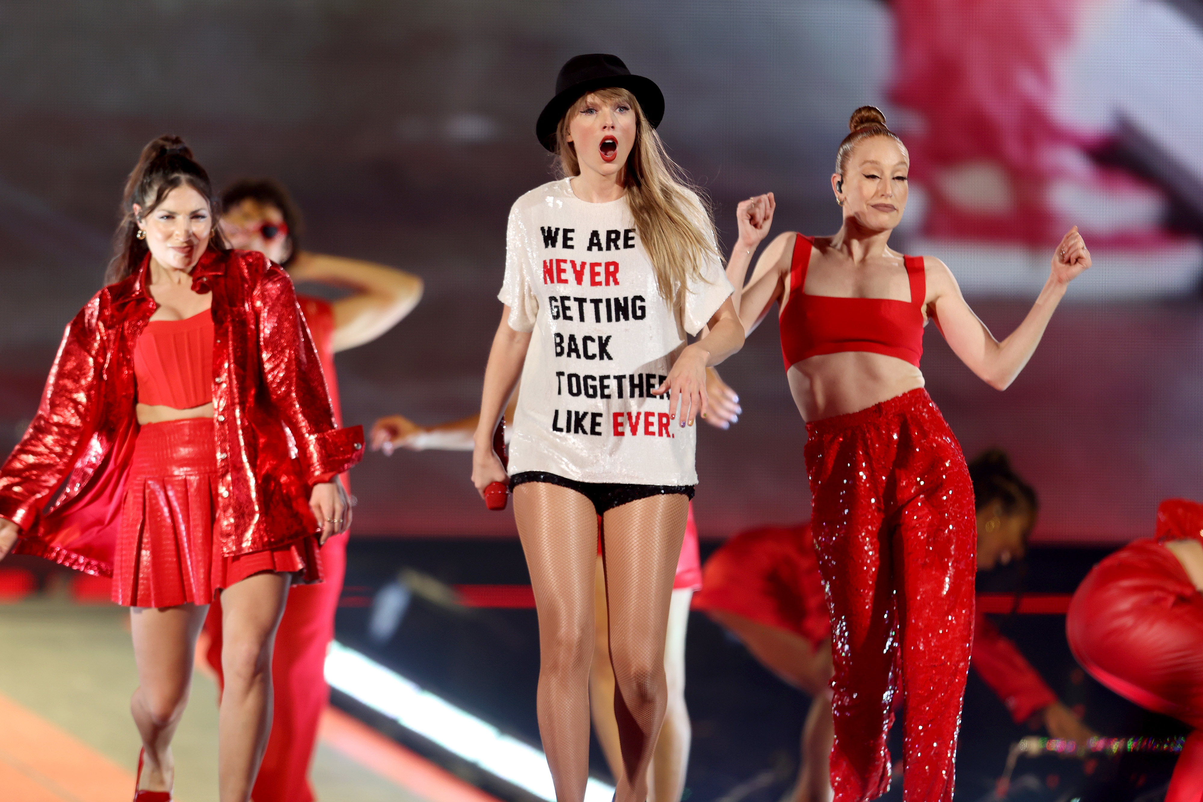Close-up of Taylor performing with dancers and wearing a &quot;We are never getting back together like ever&quot; T-shirt