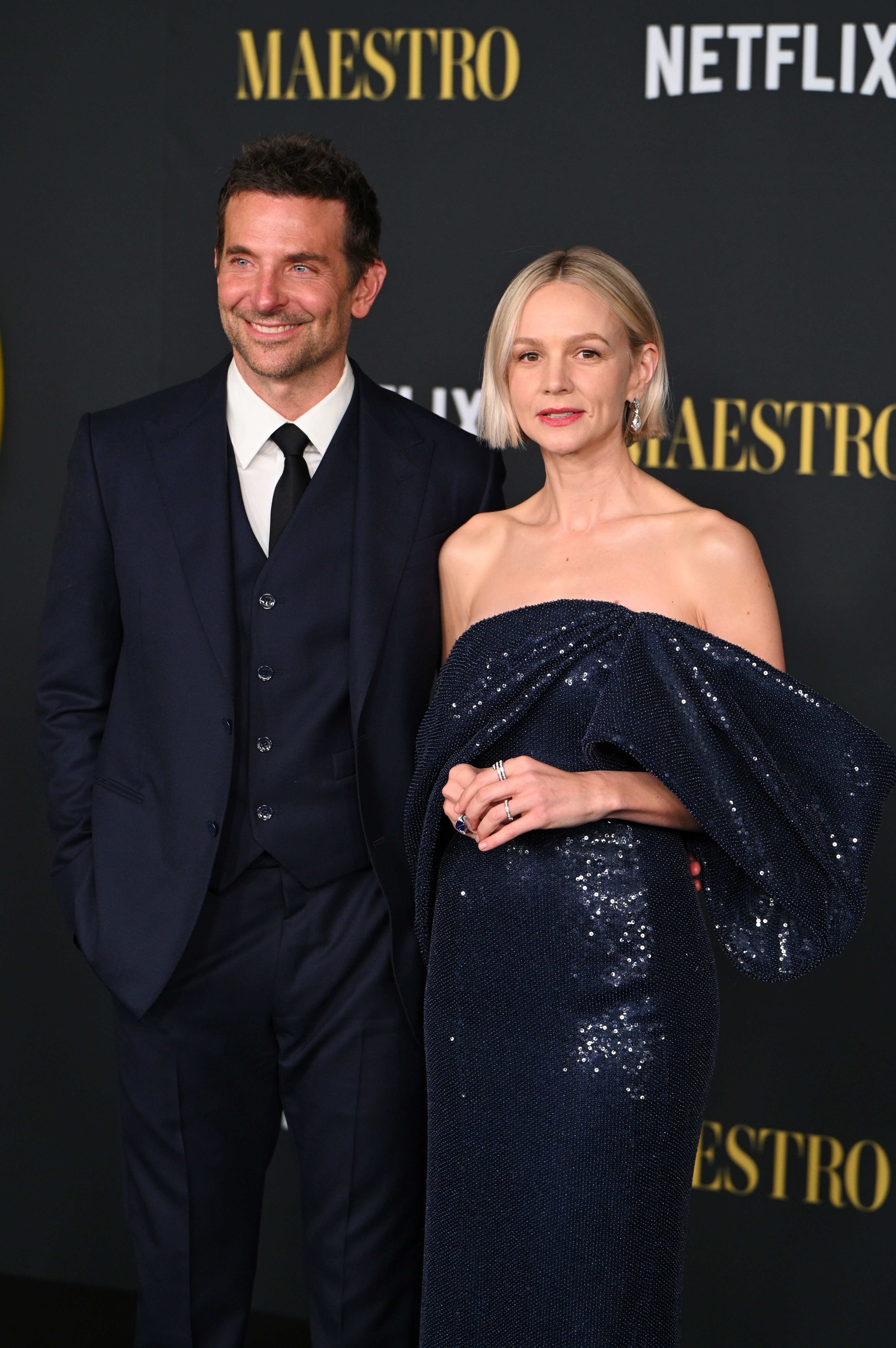 Bradley Cooper poses next to costar Carey Mulligan on the red carpet
