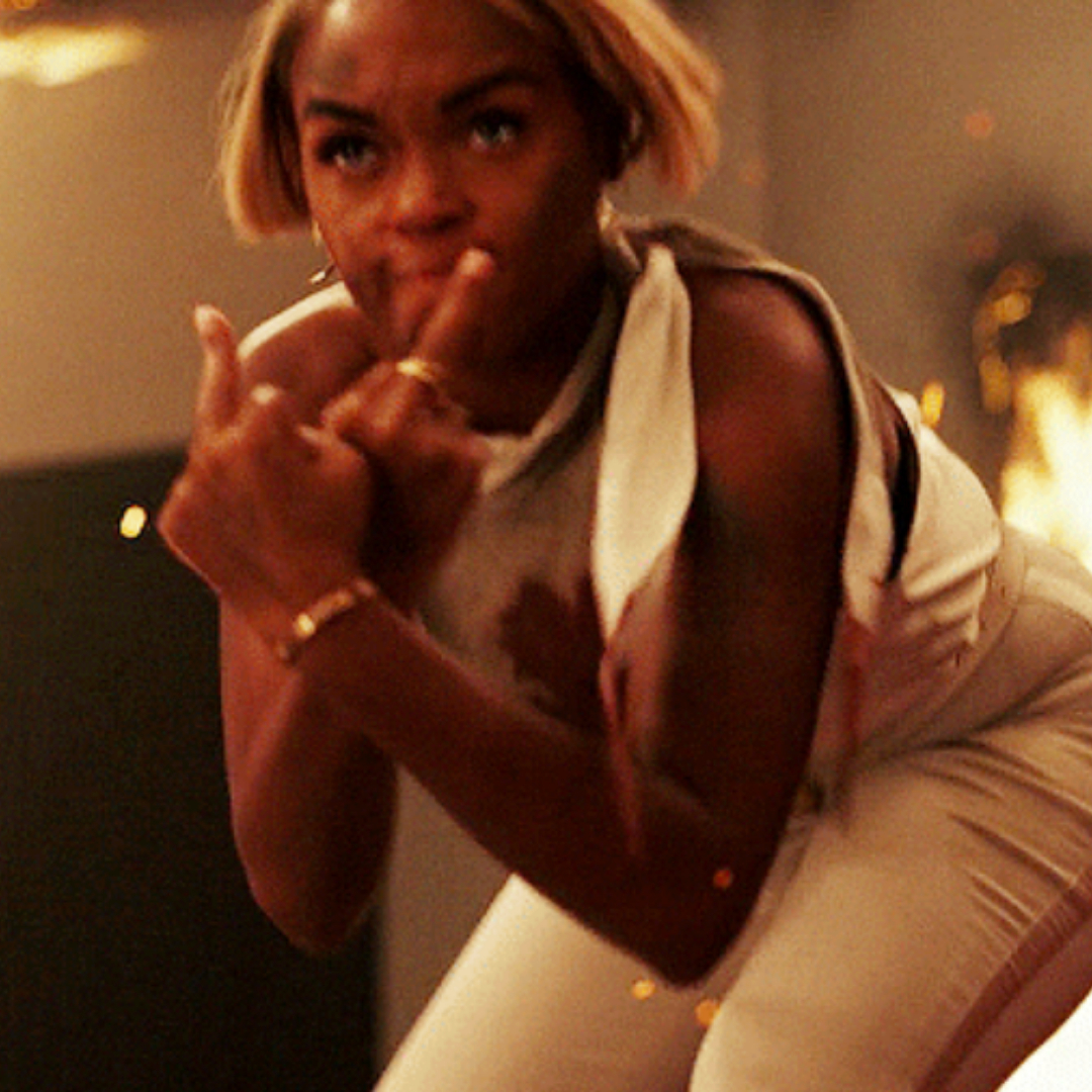 Janelle Monáe in &quot;Glass Onion&quot; flipping someone off
