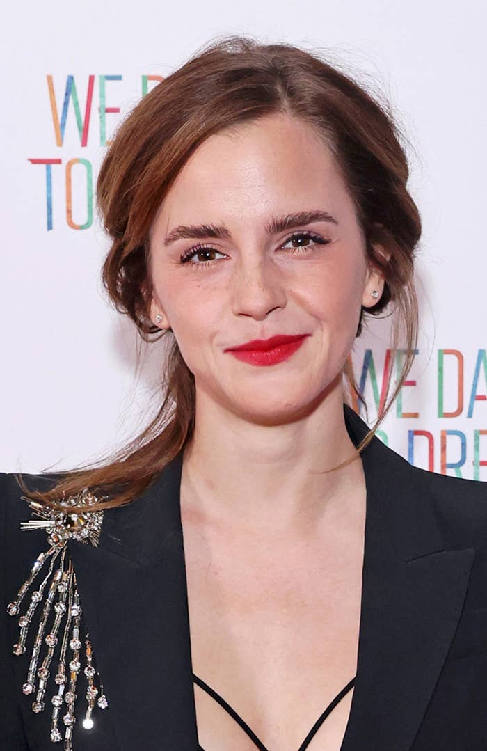 A closeup of Emma smiling on the red carpet