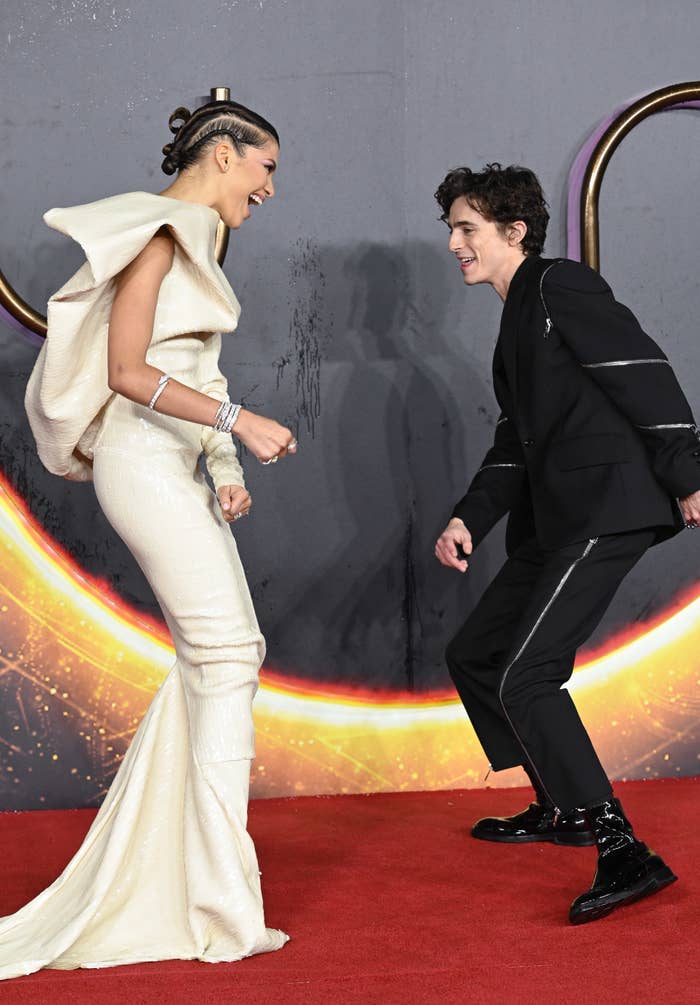 Zendaya and Timothee Chalamet playfully dancing on the red carpet