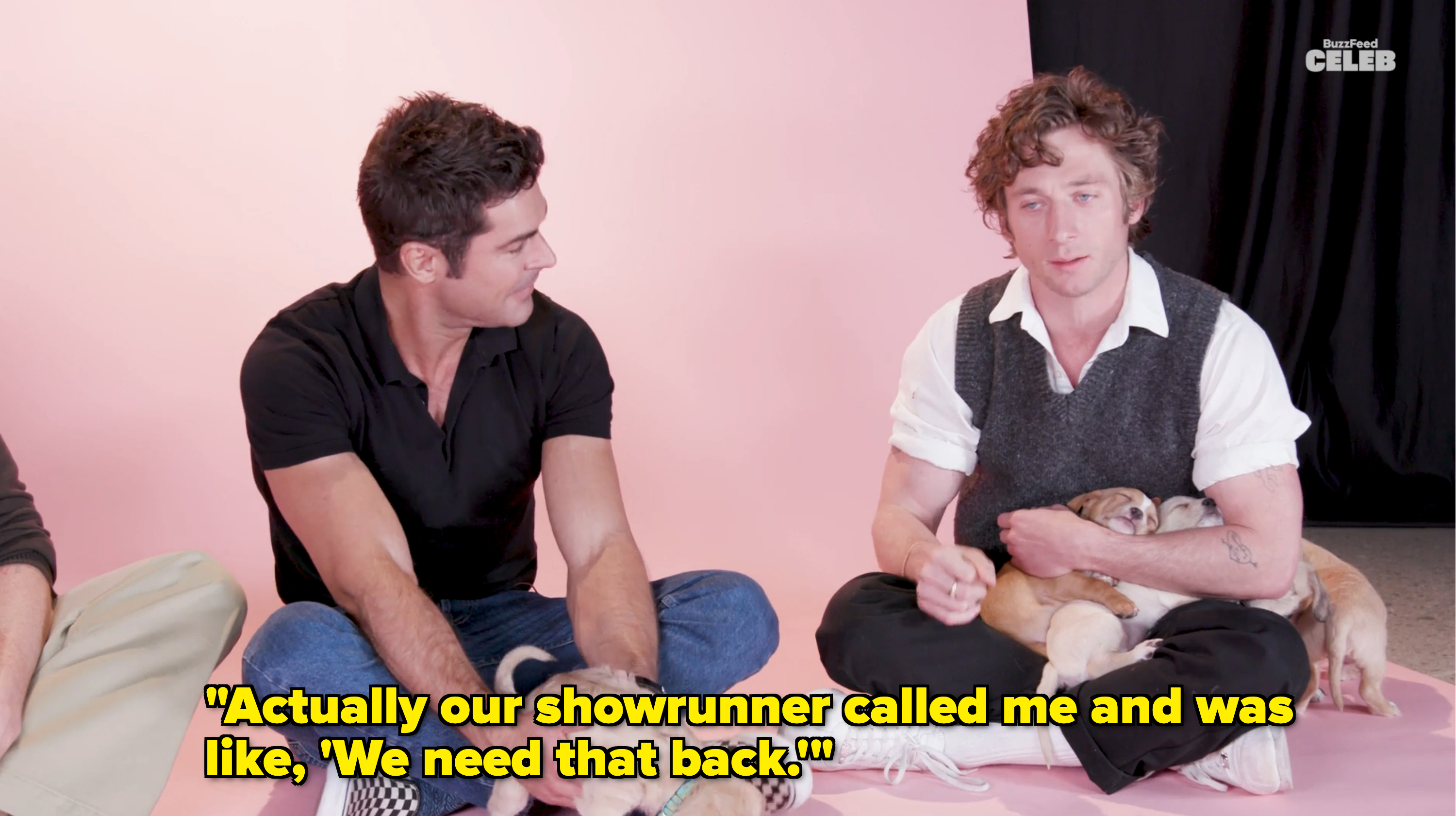 Closeup of Zac and Jeremy playing with puppies and Jeremy saying, &quot;Actually our showrunner called me and was like, &#x27;We need that back&#x27;&quot;