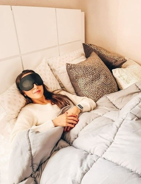 model wearing black eye mask while sleeping