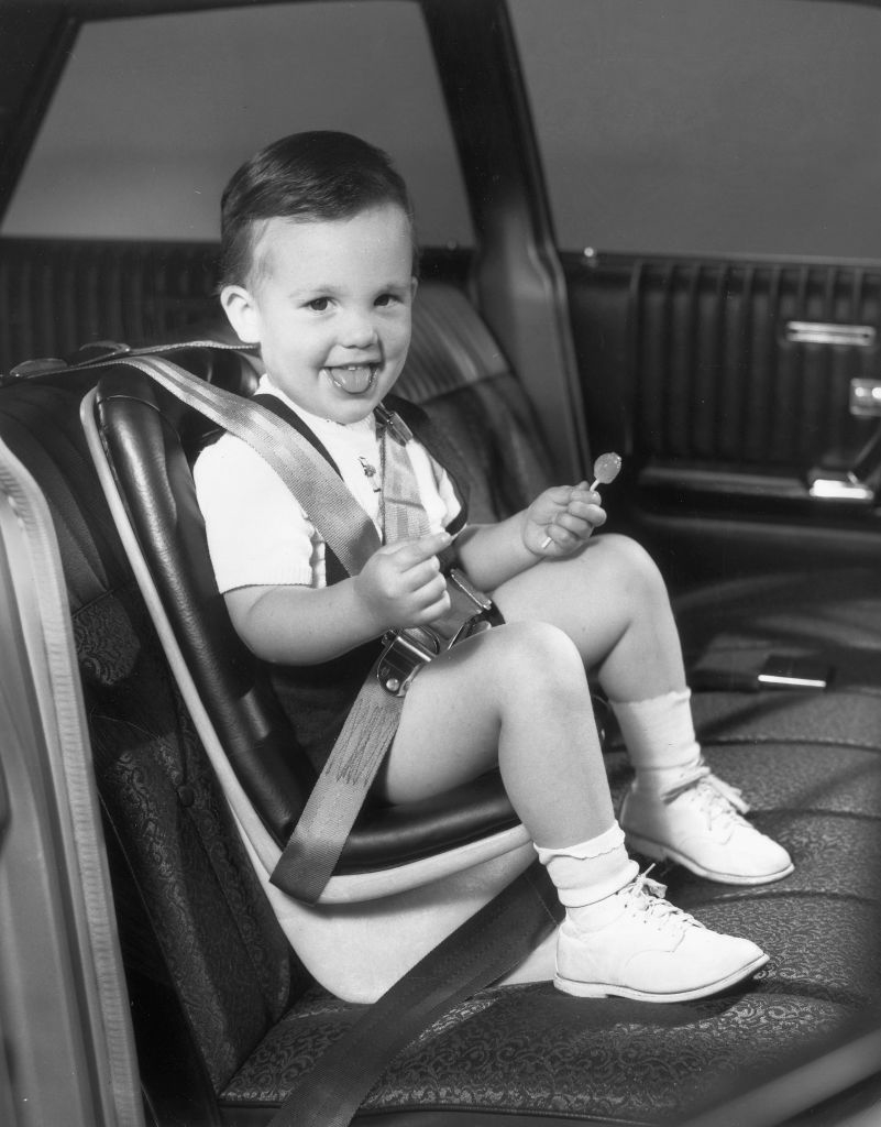 a little boy in his car seat