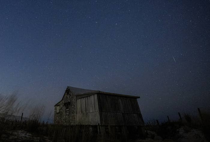 View of the starry night sky above a desolate building