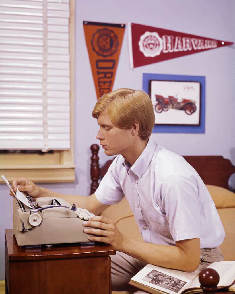 A young man using a typwriter