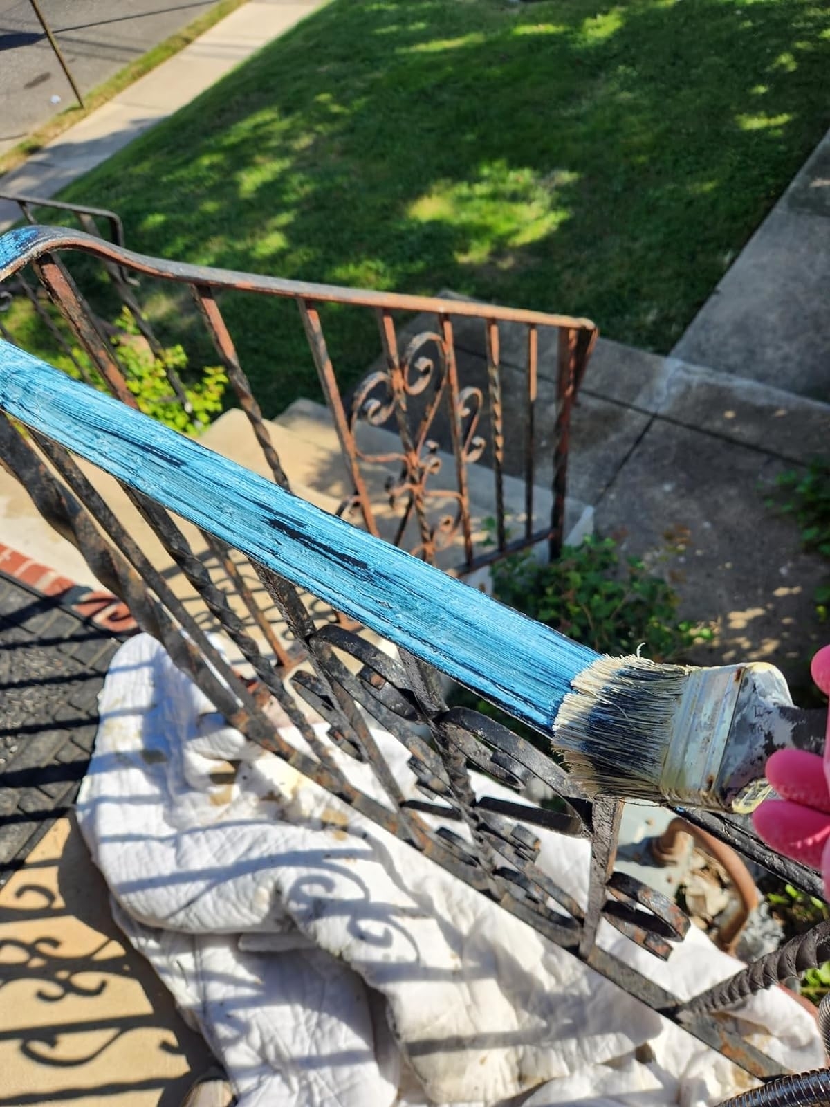 a reviewer painting rust remover on their railings