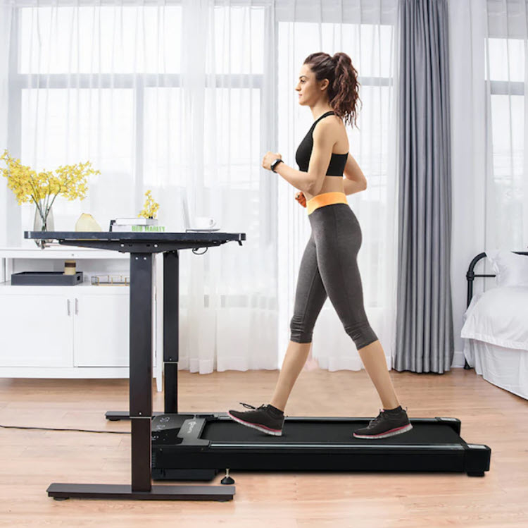 model walking on moveable treadmill under desk