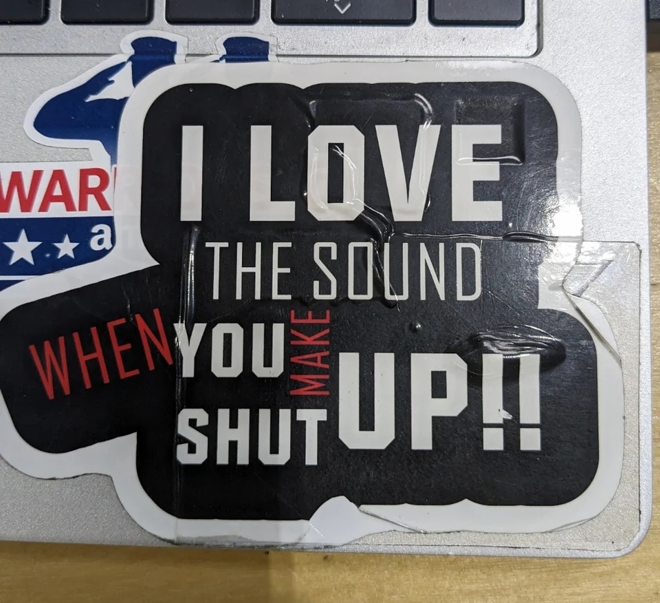a laptop sticker that reads &quot;i love the sound you shut up&quot; in white letters and &quot;when make&quot; in red letters