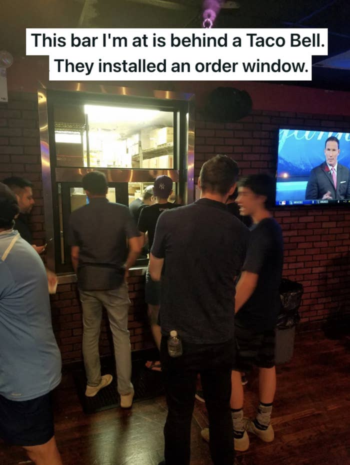 People waiting at a Taco Bell window