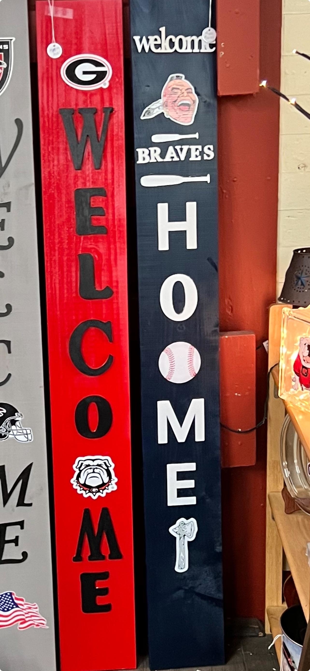 one sign that reads &quot;welcome&quot; with an image of a bulldog after the &quot;o&quot; and another that reads &quot;home&quot; with a baseball after the &quot;o&quot;