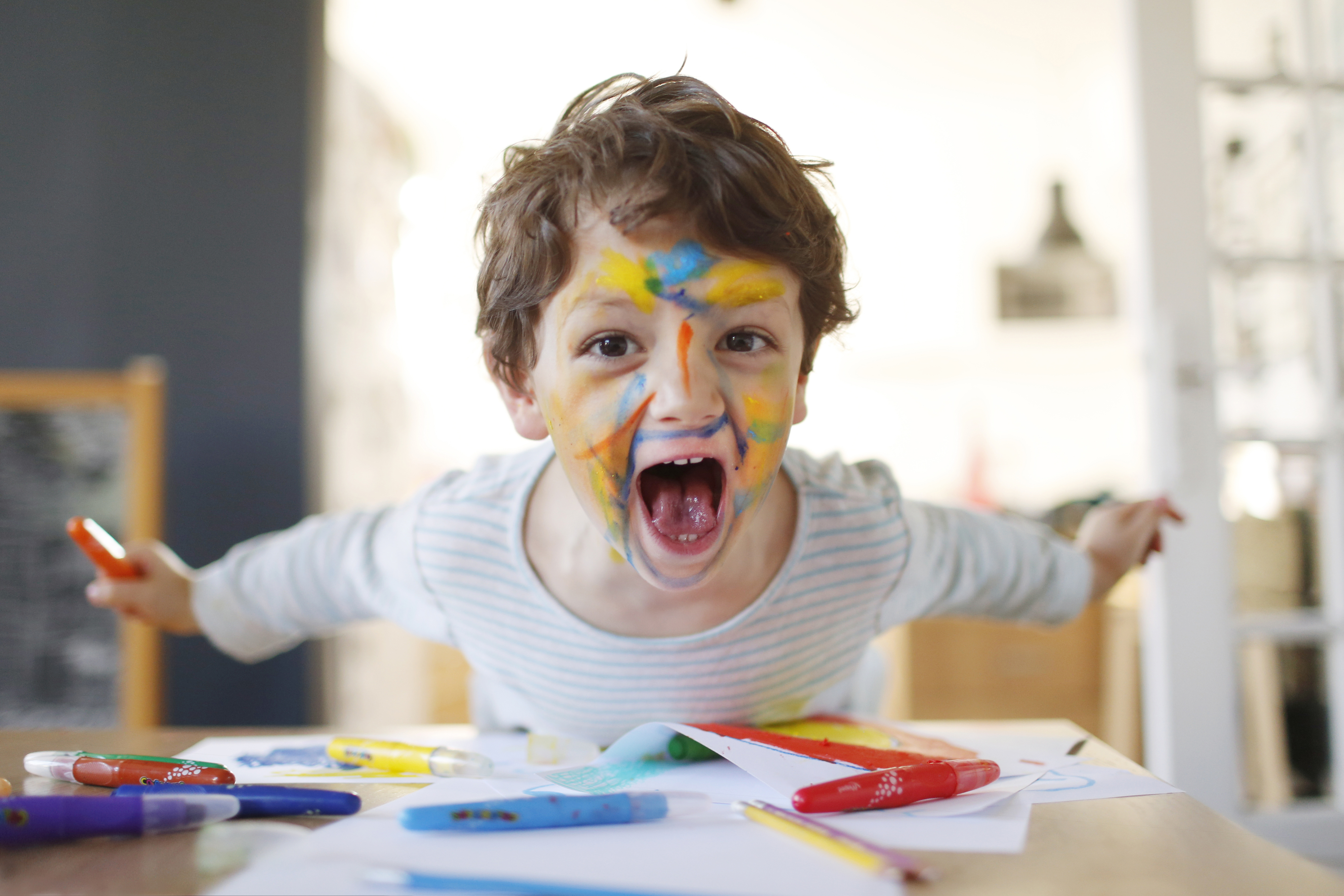 A rowdy 4-year-old with paint on their face