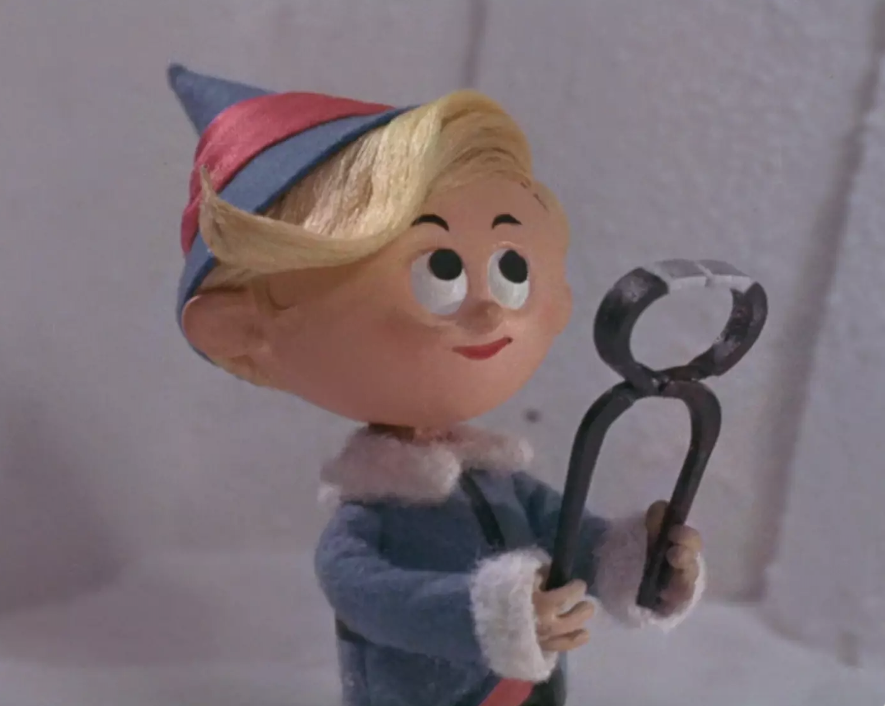 hermey the elf holding a tooth extractor