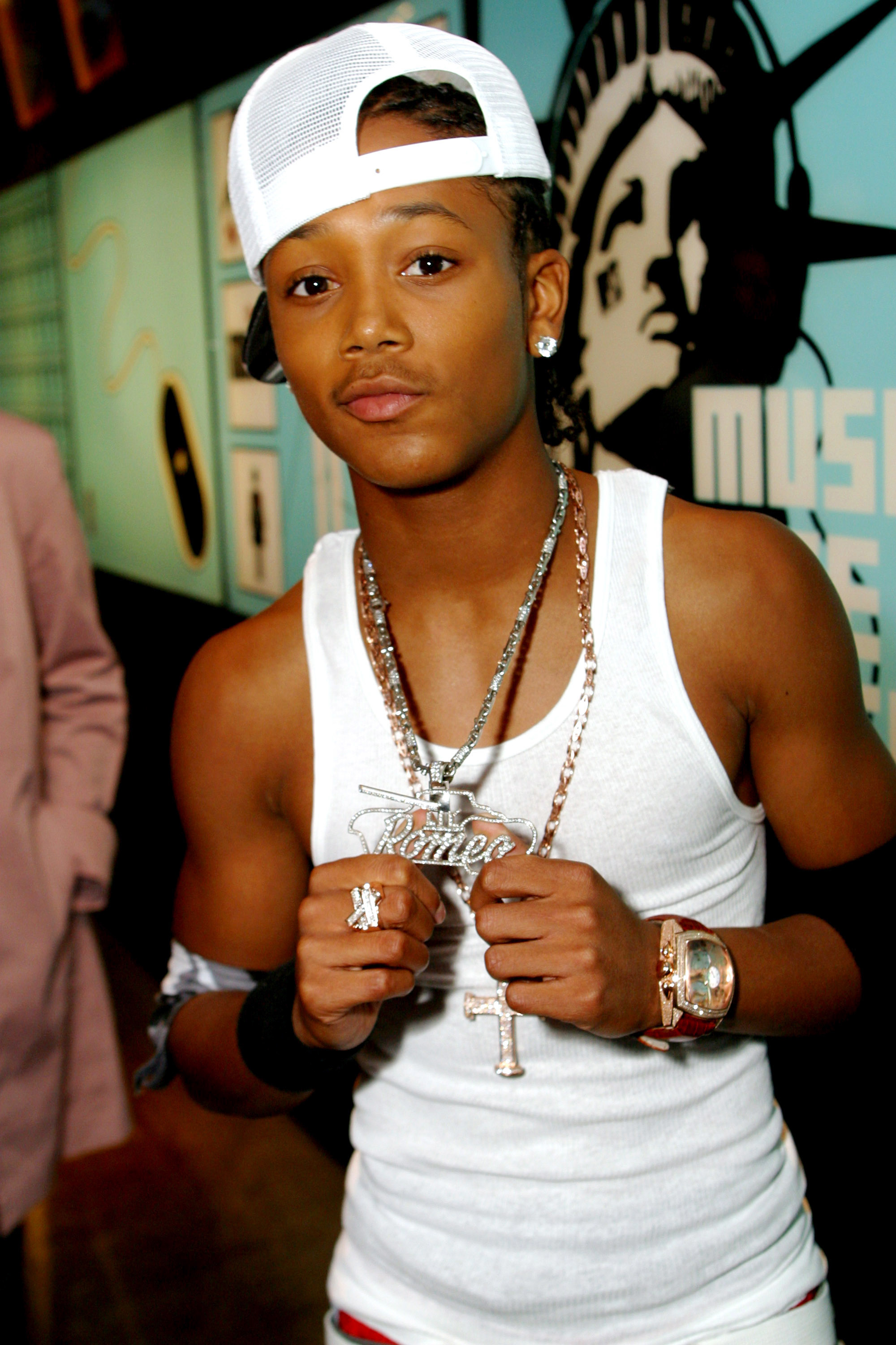 Lil Romeo holding his nameplate jewelry