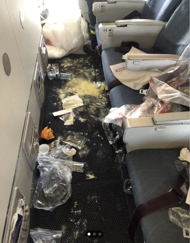 Trash is strewn across a row of the plane