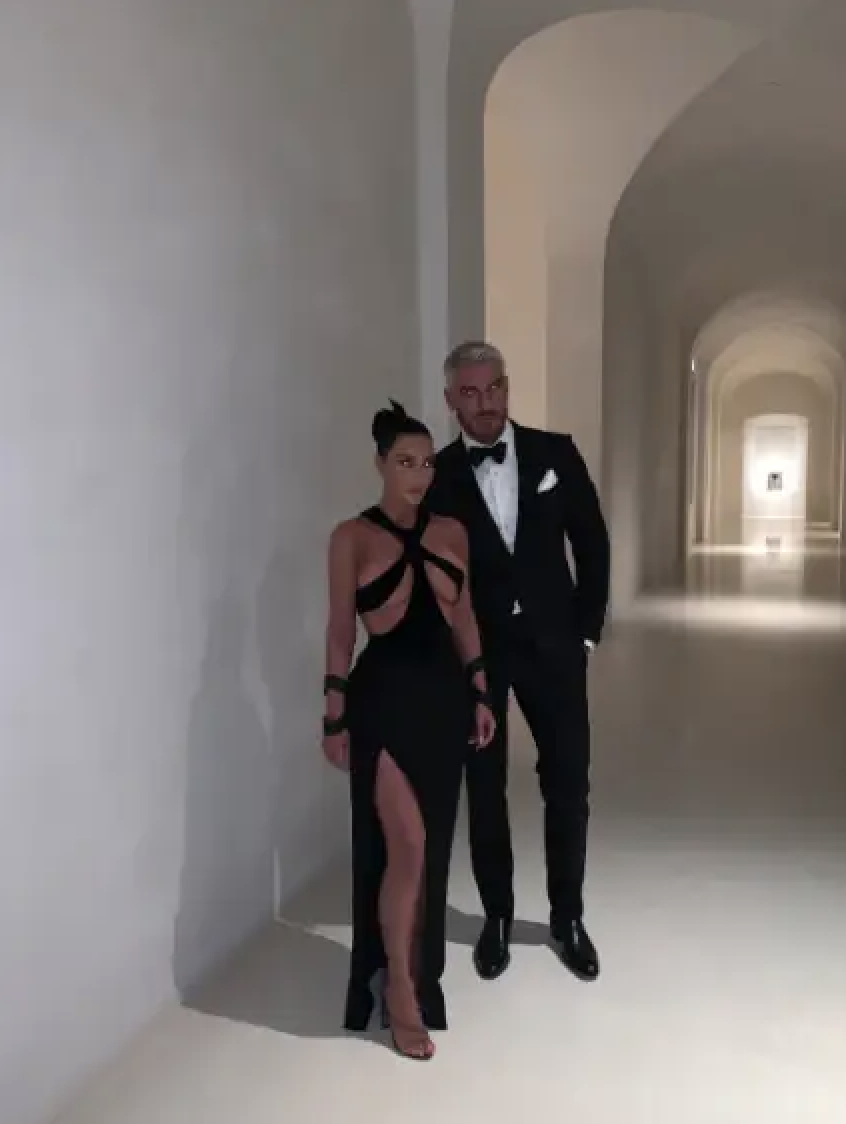 Kim standing with Chris Appleton in her completely bare hallway
